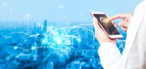 Man's hand using smartphone to connecting data information and blurred city background