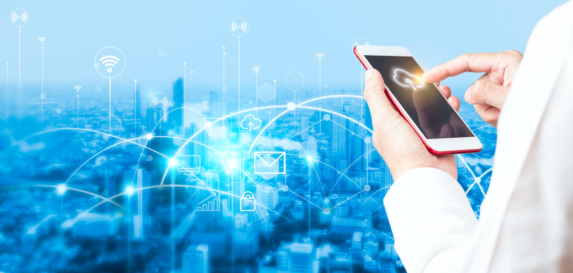 Man's hand using smartphone to connecting data information and blurred city background